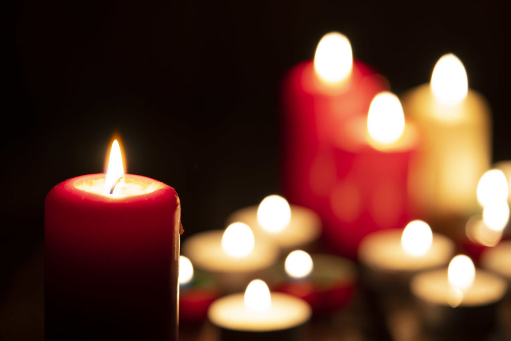Burning candles in the dark around the holidays in memory of a loved one