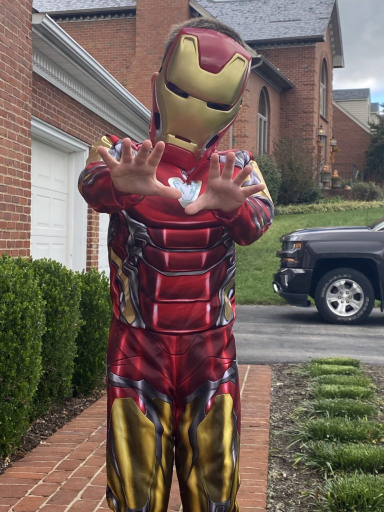A 5-year-old boy wears an Iron Man costume on Halloween.