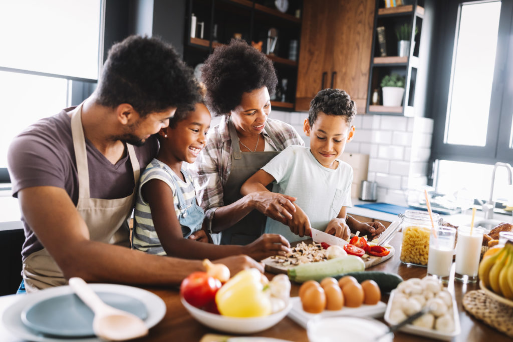 A family making dinner for a patient with a brain tumor to enjoy. Meal Train is one of the apps for caregivers to help streamline care and tasks.