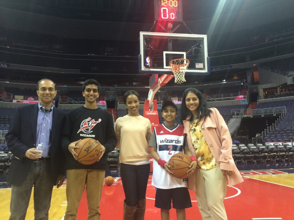 A family stands on the Washington Wizards basketball court for a 13-year-old boy's Make-A-Wish experience.