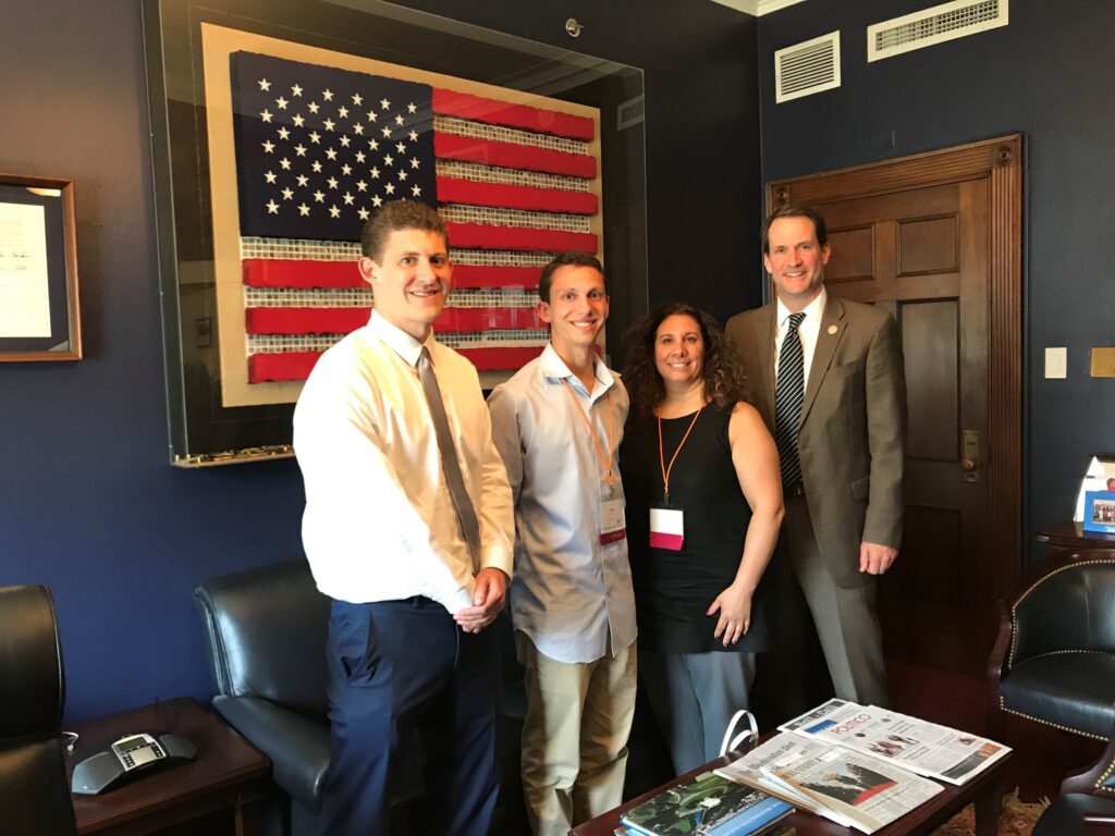 A group of four individuals, three men and one woman, stand outside a representative's office at Head to the Hill 2018.