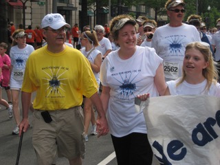 Rich, in a yellow survivor t-shirt, holds his wife's hands at the 2010 Race for Hope DC.
