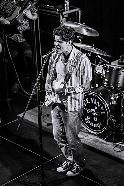 Ryan Neal performs onstage in a black and white photo. Ryan was diagnosed with dysembryoplastic neuroepithelial tumor as a child.