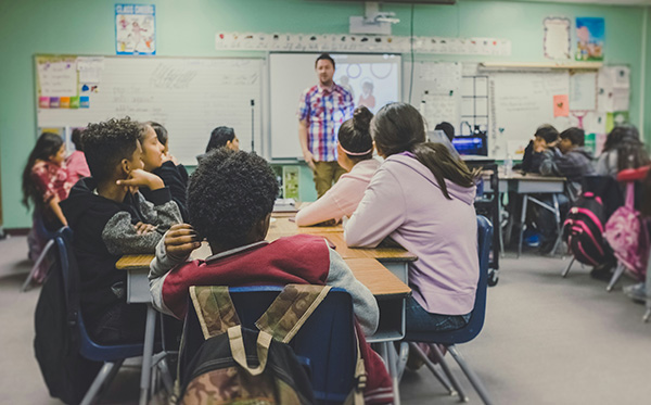 A teacher informs students about their classmate who is returning to school after a brain tumor diagnosis.