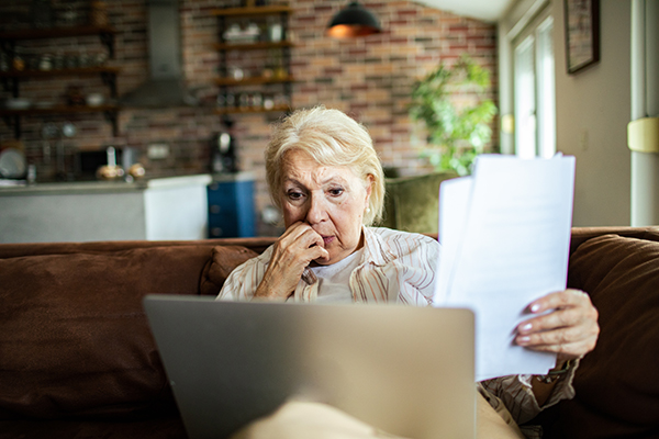 Senior woman going over her Medicare options on her laptop