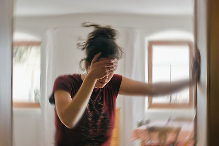 Blured photo of a woman suffering from seizure due to benign brain tumor.