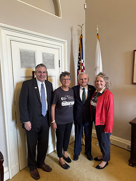 Two men in a suit, including Senator Jack Reed, stand next to two female brain tumor advocates at Head to the Hill.
