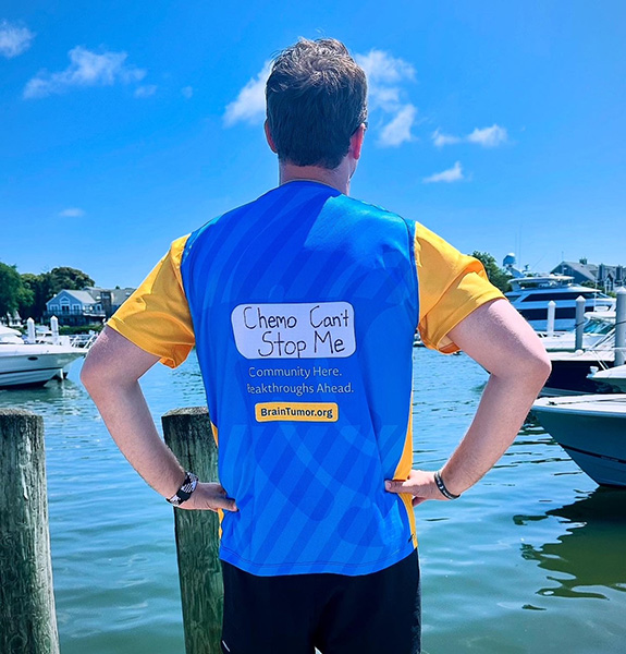 A man runs for Gray Nation Endurance with "chemo can't stop me" written on the back of the shirt.
