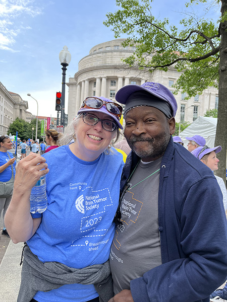 A white woman stands next to her husband, a Black man, in downtown DC for Race for Hope DC.