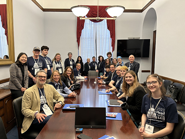 A group of 20+ brain tumor advocates sit in a member of Congress' office to advocate for the BRAIN Act and other important matters.