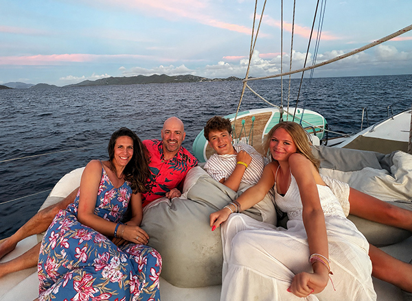 A family of four relax on a boat as the sun sets. Biomarker testing unlocked answers for them after brain surgery.